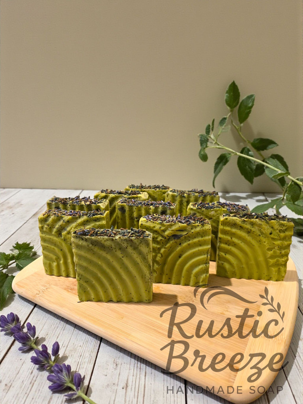 Rustic Breeze Handmade Soap with green soap bars on a wooden board.