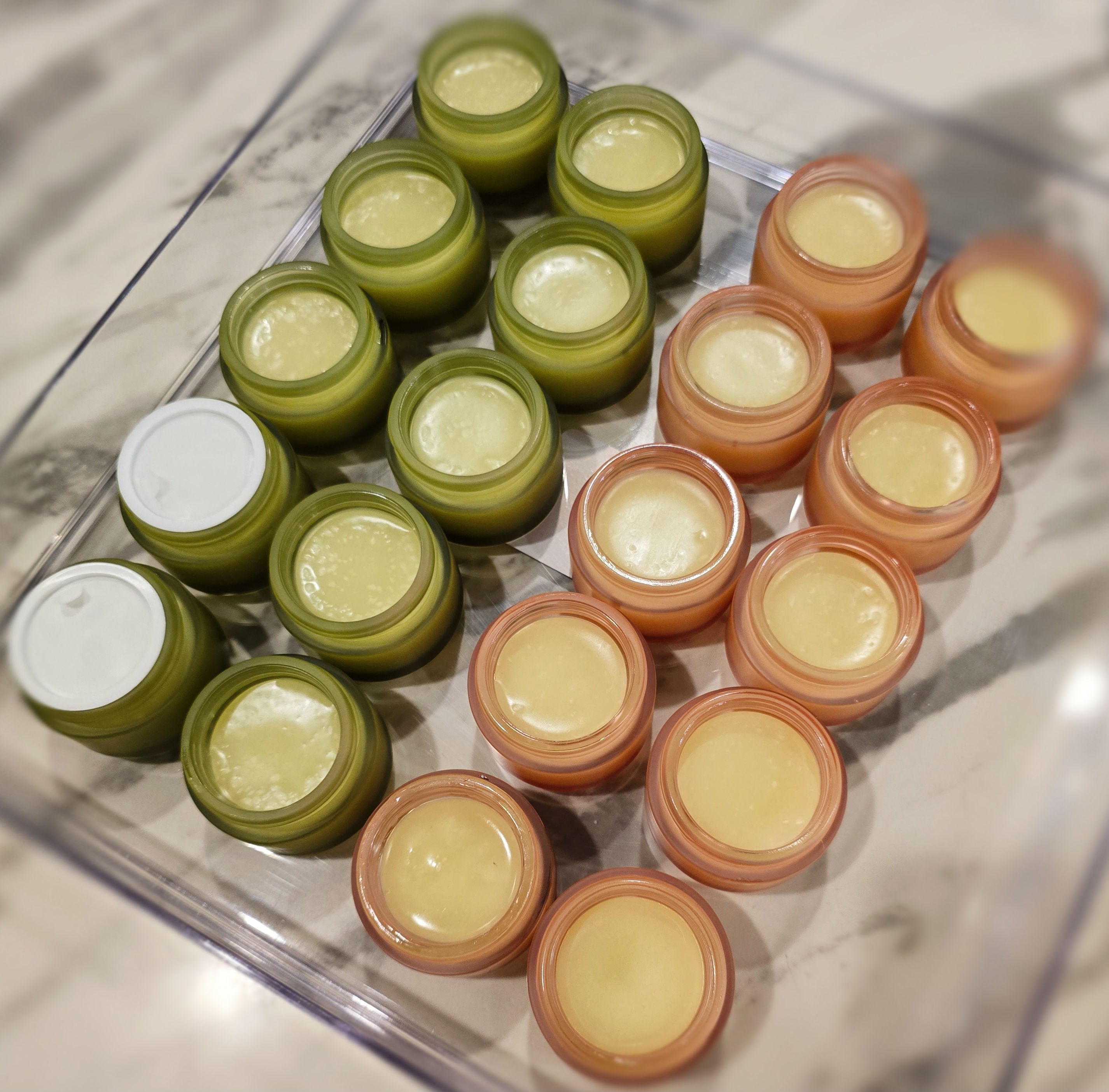Various jars of LadyCare Glow – Botanical Bar Gentle • Calming • Nourishing arranged in a tray